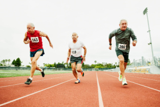 Senior male track athletes running sprint on track during race